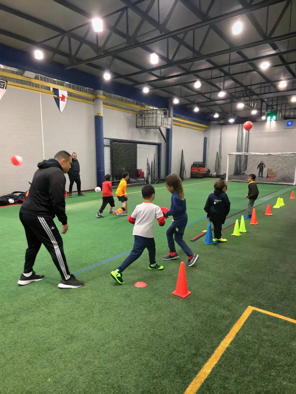 An image of BFC BRIVE FUTSAL CLUB coaches conducting a futsal clinic for underprivileged children, emphasizing the club's commitment to inclusivity and accessibility.