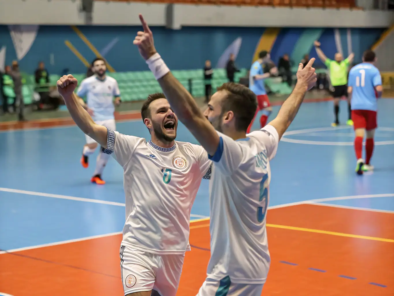 A vibrant image of futsal players celebrating a goal, highlighting the camaraderie and teamwork fostered by the sport.